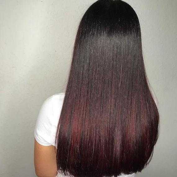 Back of woman’s head with black and red ombre hair, created using Wella Professionals.