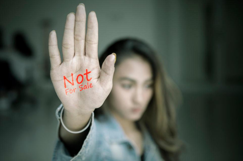 Female teenager showing text of not for sale